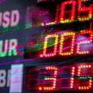 Electronic financial ticker board showing USD EUR and GBP with red and green LED numbers and overlaid line graphs