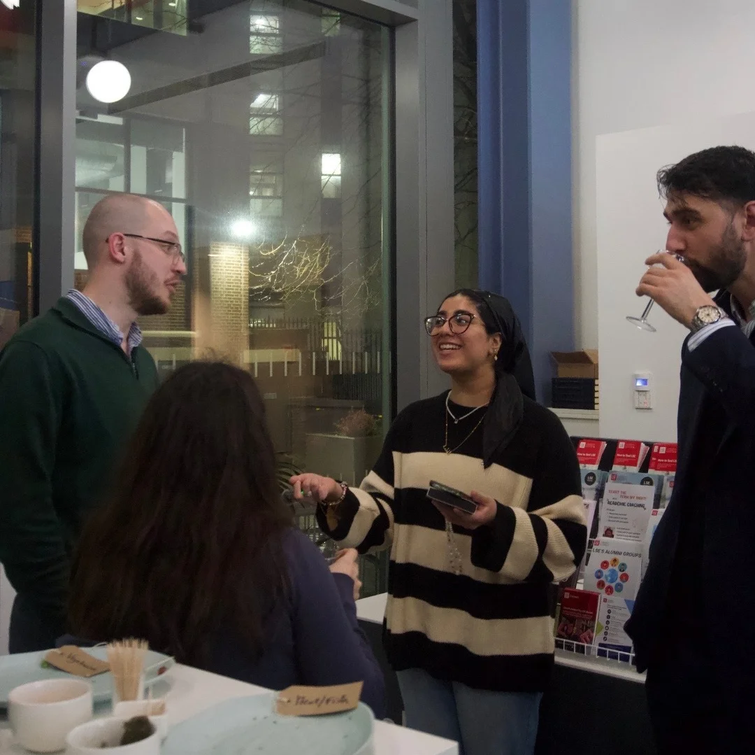 group stand and talk at an alumni event