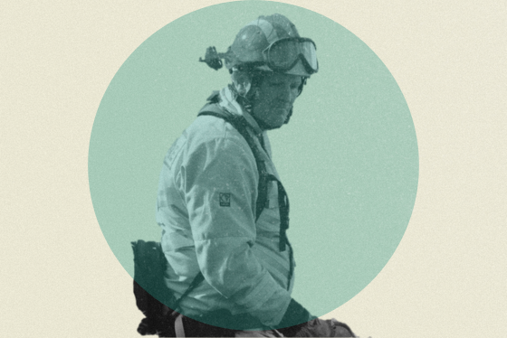 Greyscale firefighter in a blue circle carrying out prescribed burning