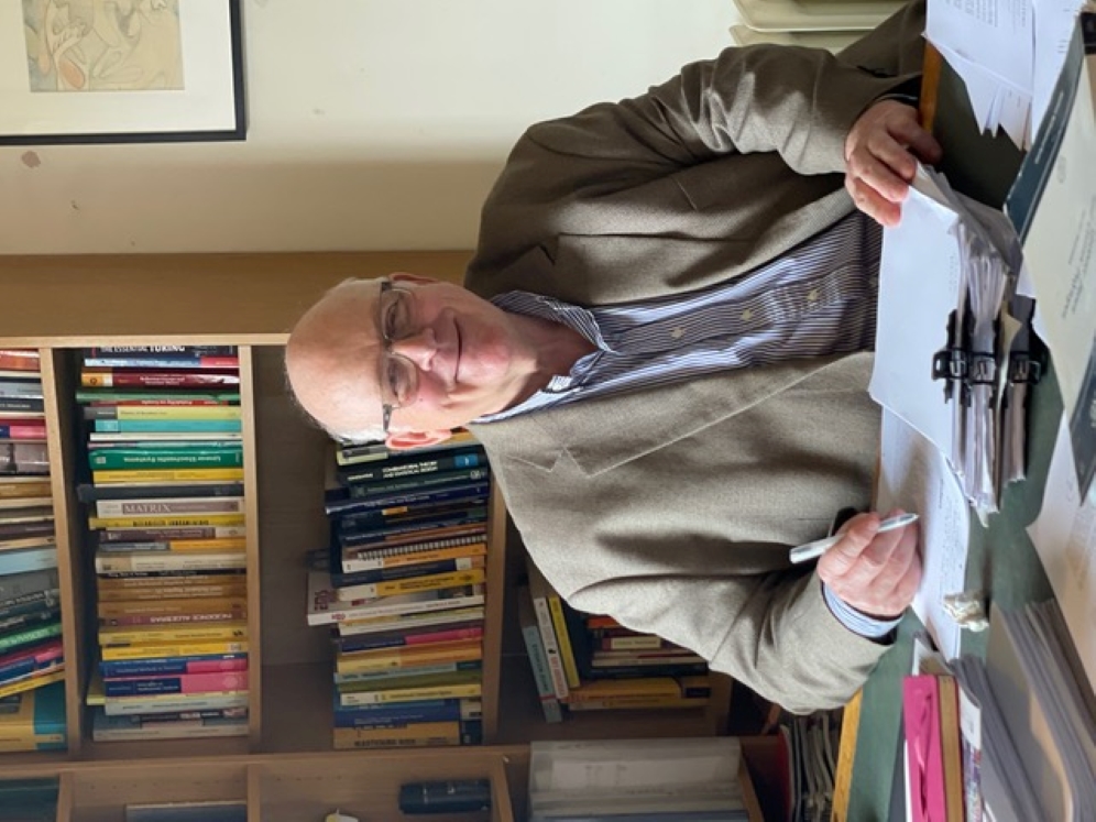 Henry Wynn sitting at a desk, pen in hand.