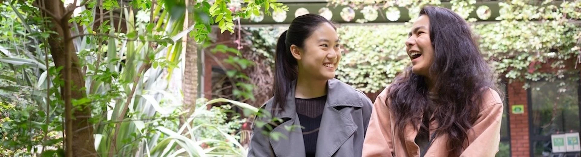 Two students talking in a garden