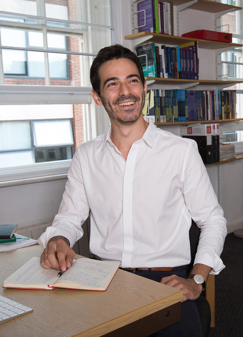 Huseyin Naci in an office, sat at a desk