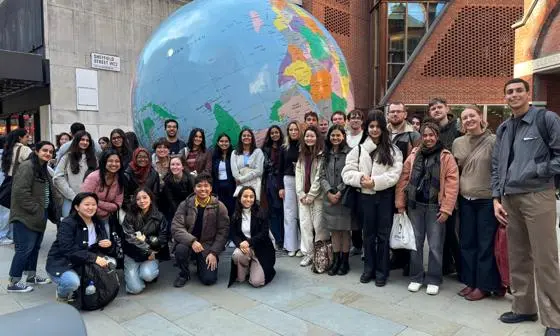 ID Students in front of globe
