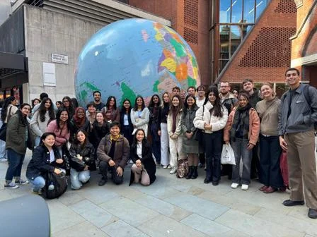 ID Students in front of globe