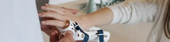 Person being fitted with medical device on hand