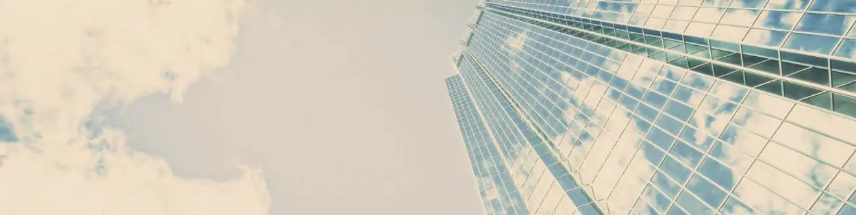 A tall skyscraper with clouds