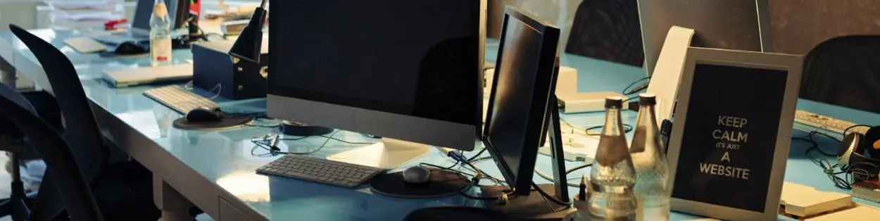 a row of desks with computers