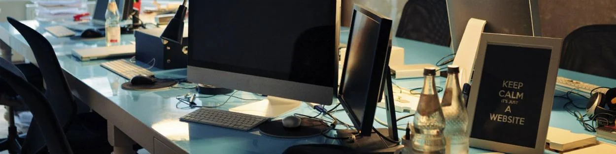 a row of desks with computers