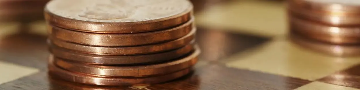 a pile of coins on a chess board
