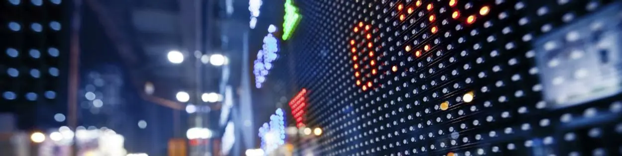 a busy city with a digital board