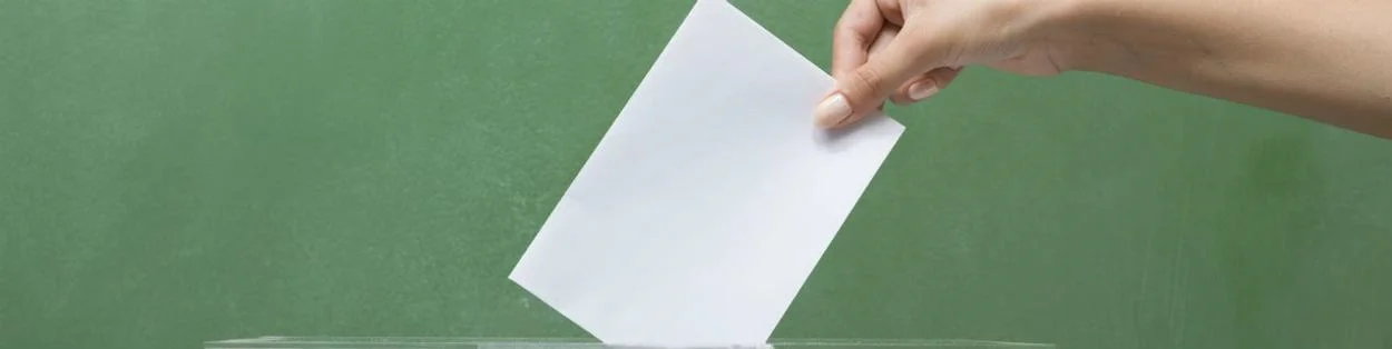 a woman putting a note into a box
