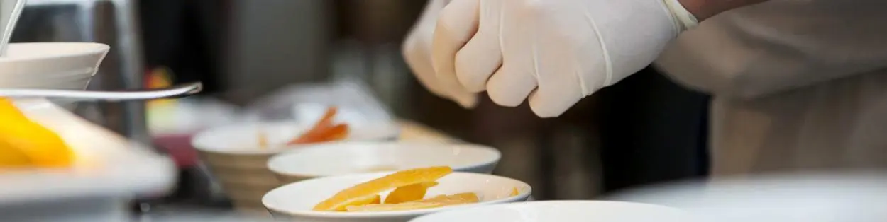 a gloved chef preparing food
