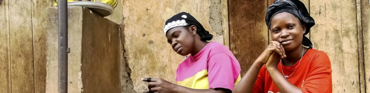 Two women sitting outdoors.