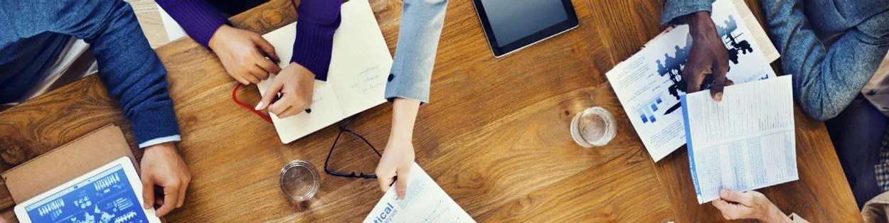 workers at a desk with paperwork