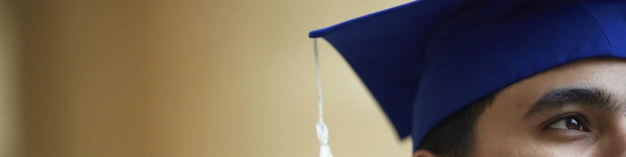 a young man wearing a morterboard for graduation