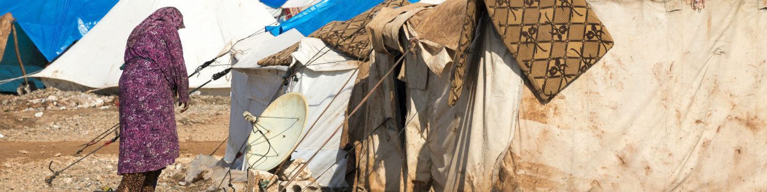 a woman walking by a campsite
