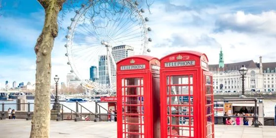 red phone boxes in front of the London eye