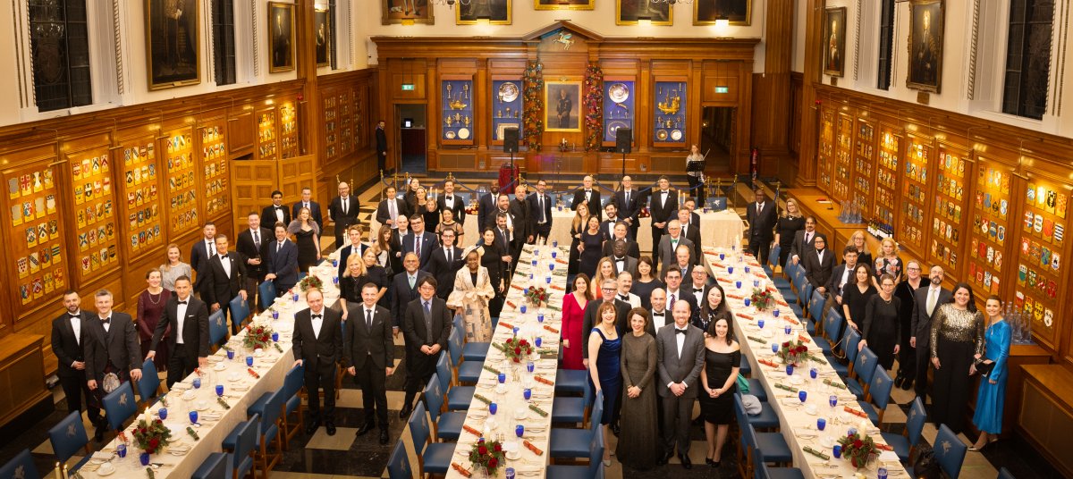People in formalwear in old wooden hall