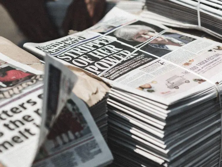 Stacked newspapers.