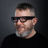 A headshot of Adam Greenfield from the shoulders up