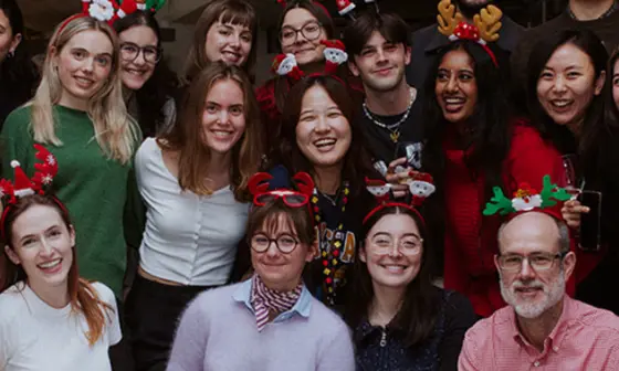 A large group of students smiling to camera at the Geography and Environment festive party