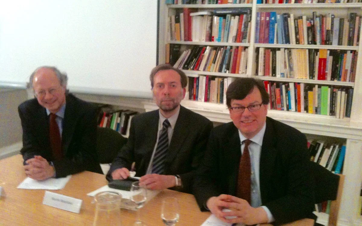 three men sitting at a table