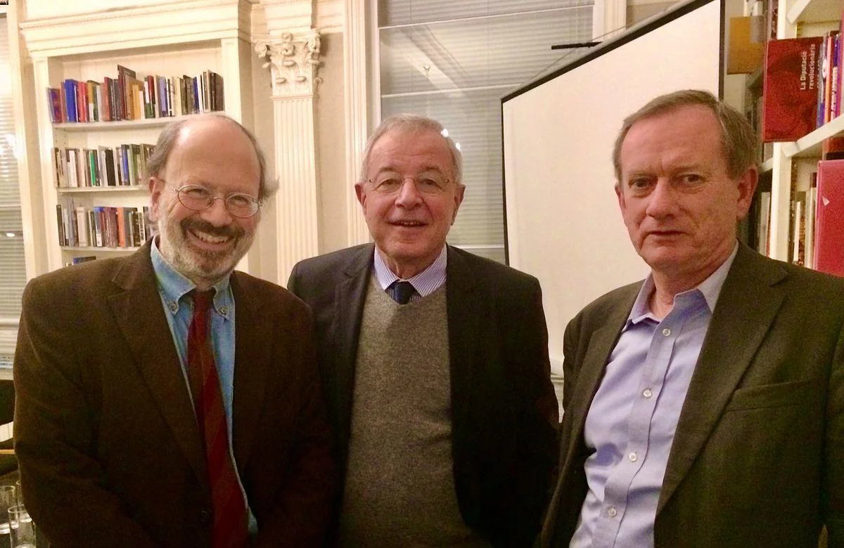 three men standing in a room