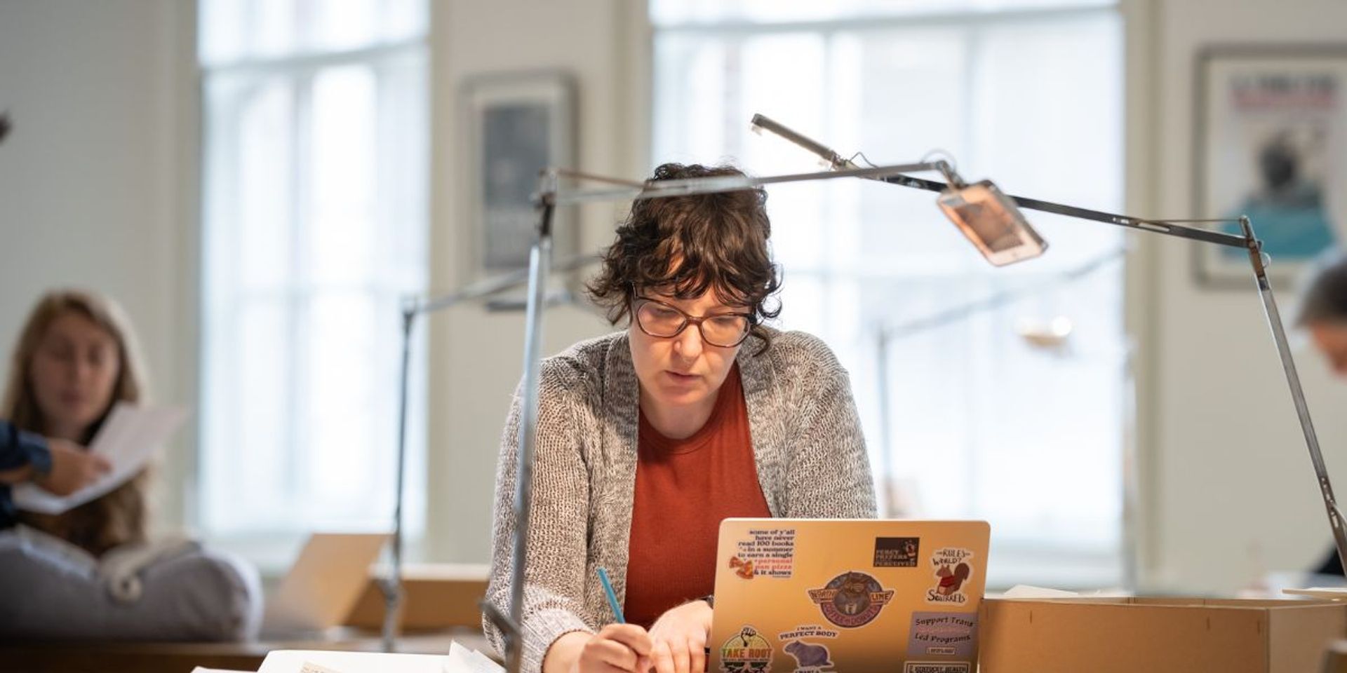 A person in the reading room working at a computer.