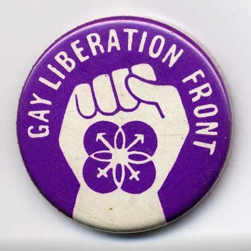 A Gay Liberation Front badge. Purple. Shows a clenched fist