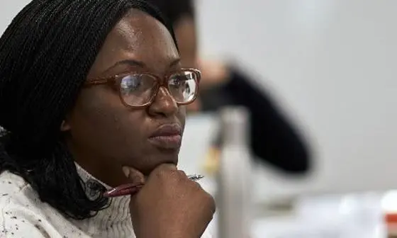 A professional woman wearing glasses in class.