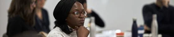 A professional woman wearing glasses in class.