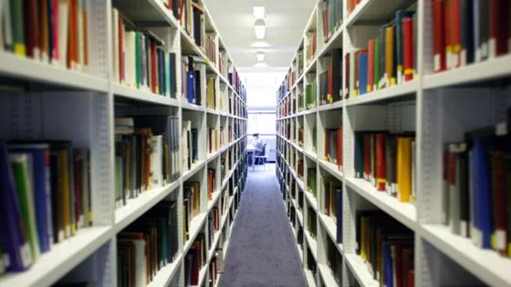 A view of LSE Library from between bookshelves.