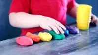 A child playing with Play-Doh.