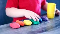A child playing with Play-Doh.