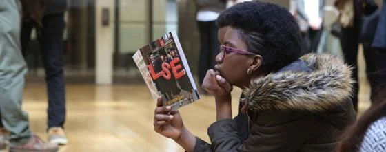 A student reading a brochure at an LSE Open Day