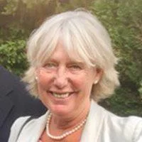 Headshot of Rita Golden, she is wearing a jacket and a pearl necklace.