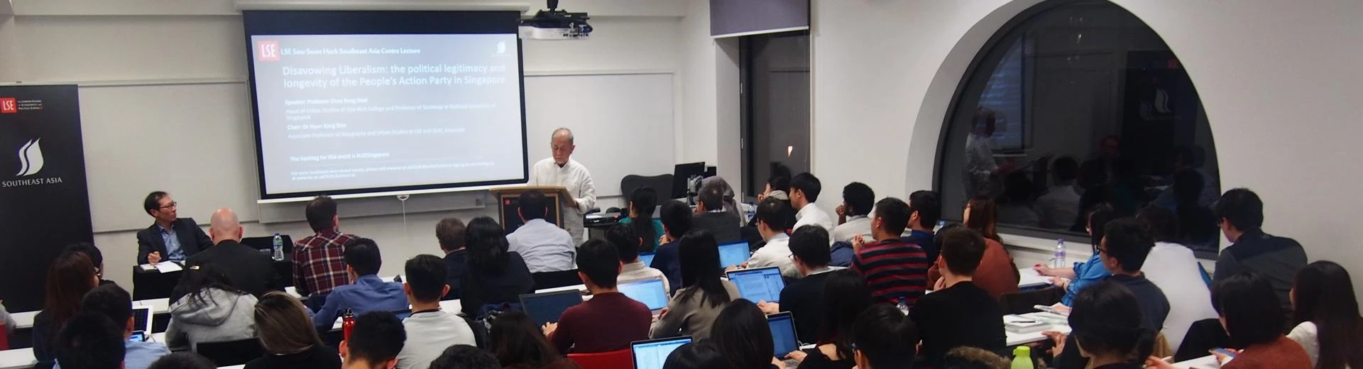 A picture from a SEAC event showing a speaker presenting his work to an attentive audience