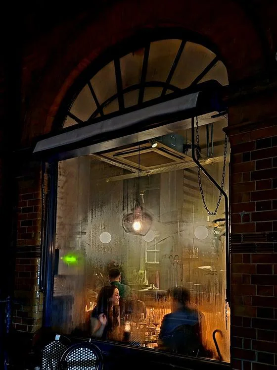 people dining at a restaurant through a window