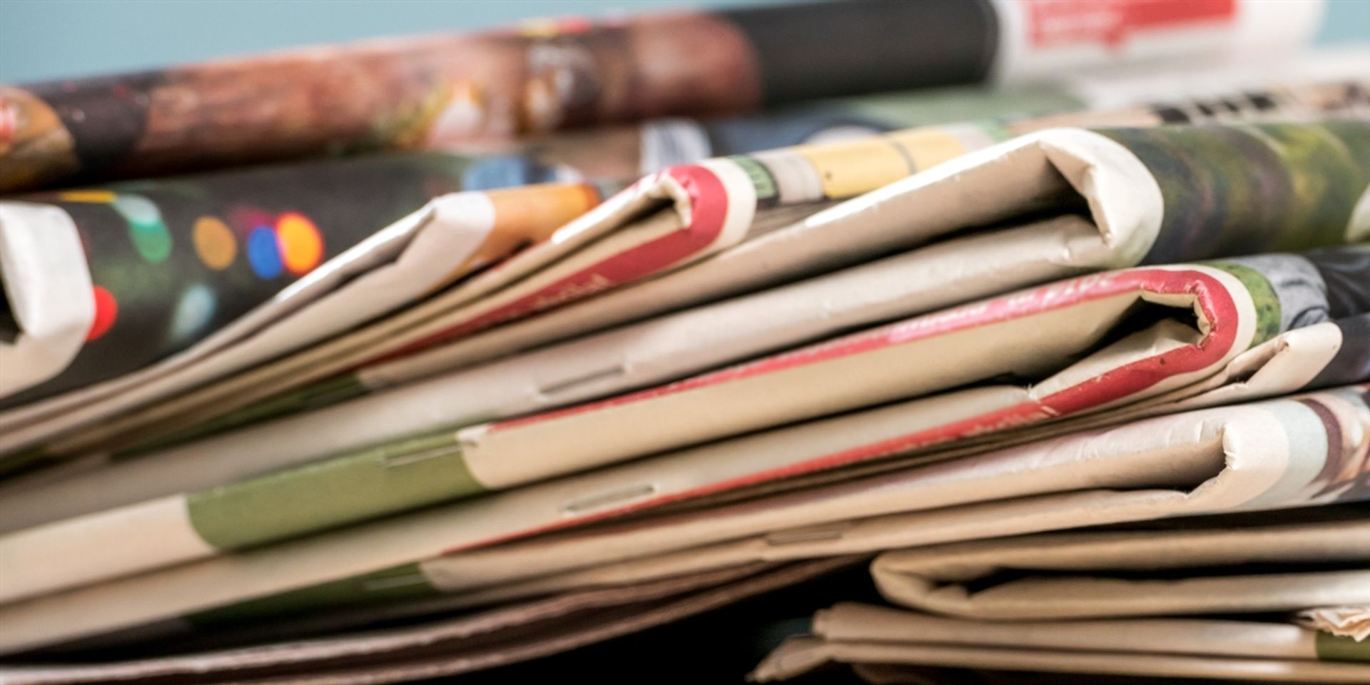 a stack of coloured newspapers