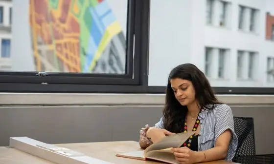 Student studying with artwork behind