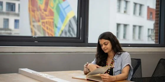 Student studying with artwork behind