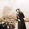 A woman stood on a plinth in Trafalgar Square addressing a crowd