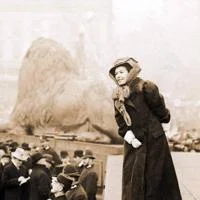A woman stood on a plinth in Trafalgar Square addressing a crowd