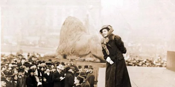 A woman talking to a crowd at Trafalgar Square in London.