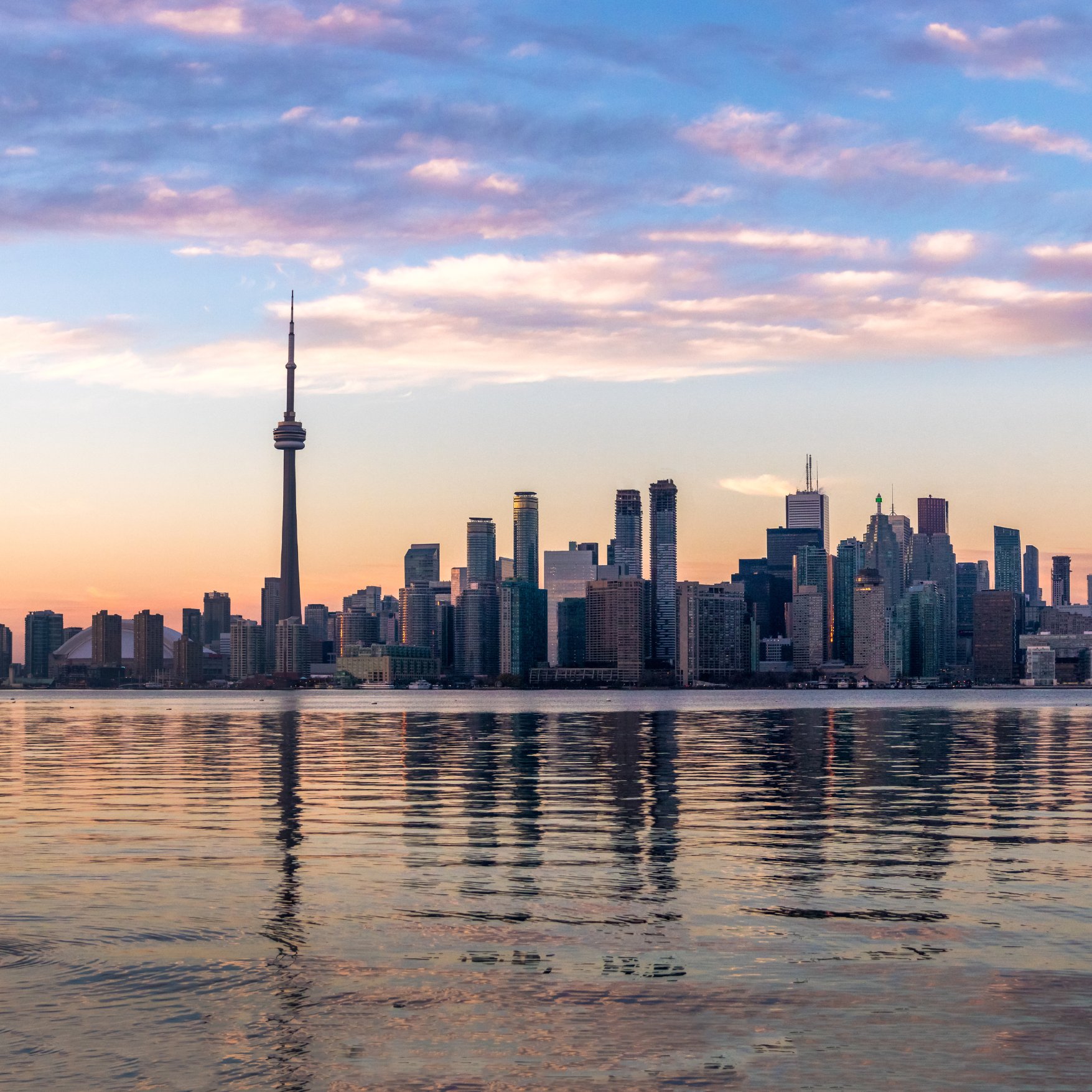 A view over the sea to the city of Toronto at sunrise including skycrapers 