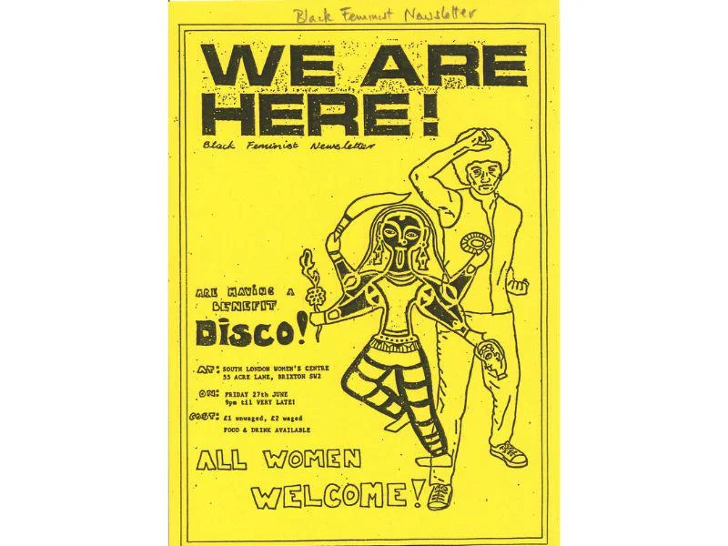 A yellow poster with WE ARE HERE! on it.