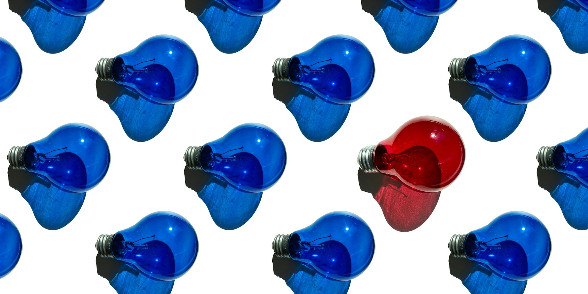 One red among many blue lightbulbs