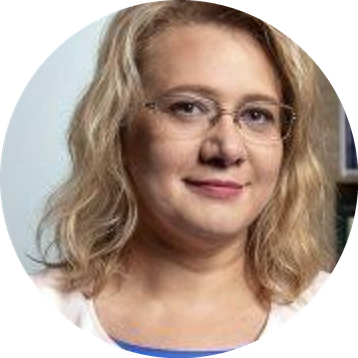 Headshot of Iryna small smile wearing glasses and with shoulder length blond hair.