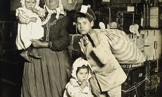 Italian family (mother and children) in the baggage room, Ellis Island, 1905