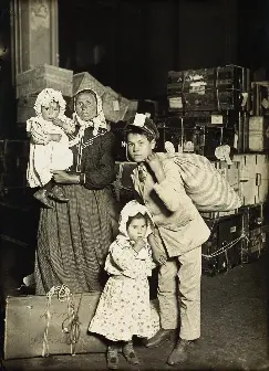 Italian family (mother and children) in the baggage room, Ellis Island, 1905